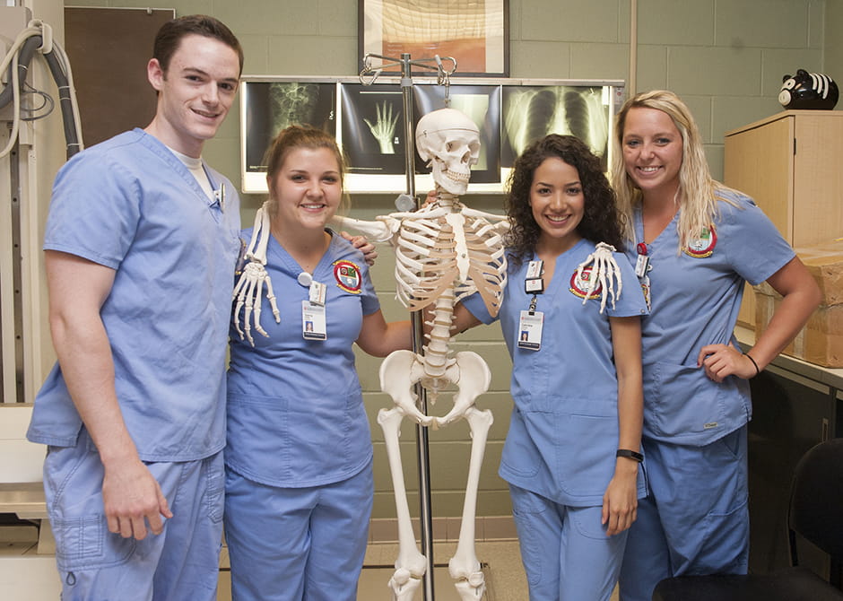 group picture of students and a skeleton 