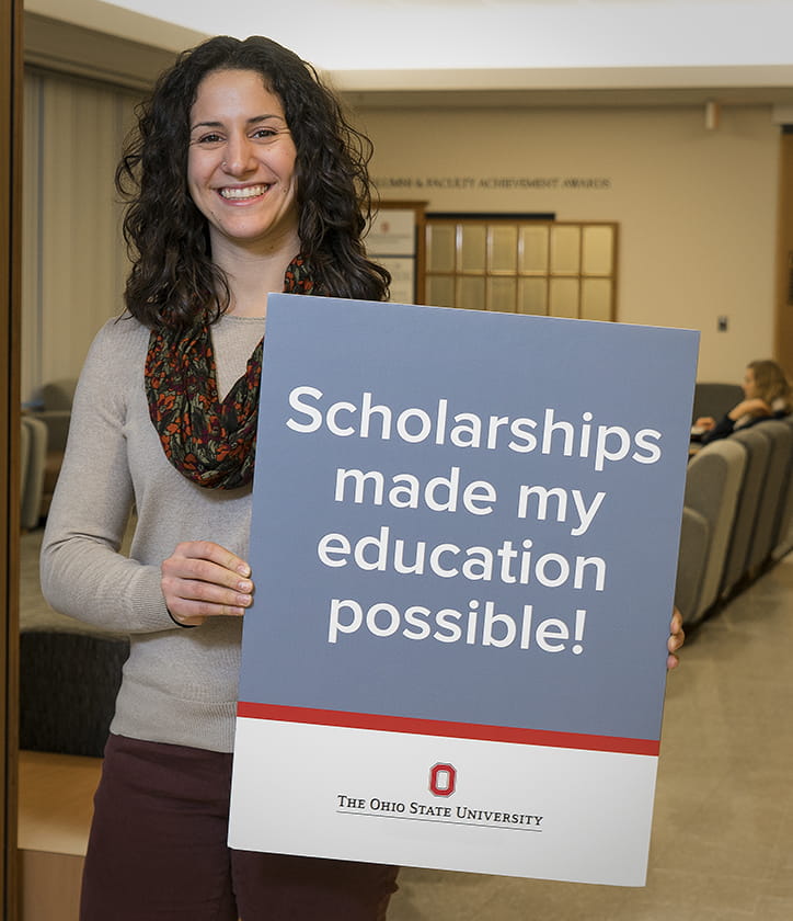 Julia Mazzaralla holding a scholarships made education possible poster 