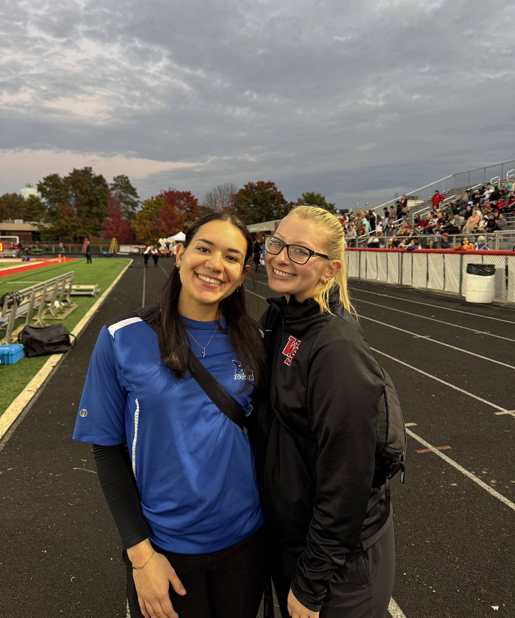 Gabi at Clinical site on a track field with an athlete