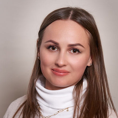 Headshot of Oxana smiling wearing white shirt 