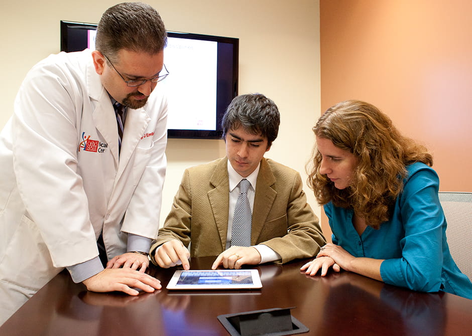 student and doctor looking on data 