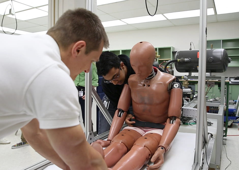 students preforming test on Biomechanics dummy 