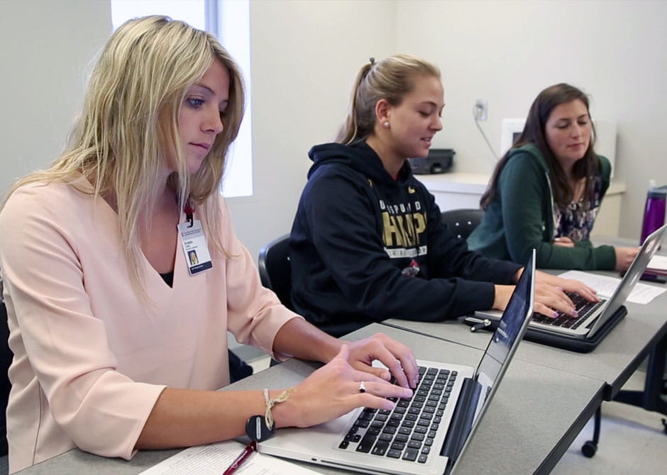 students at class  using their laptop 