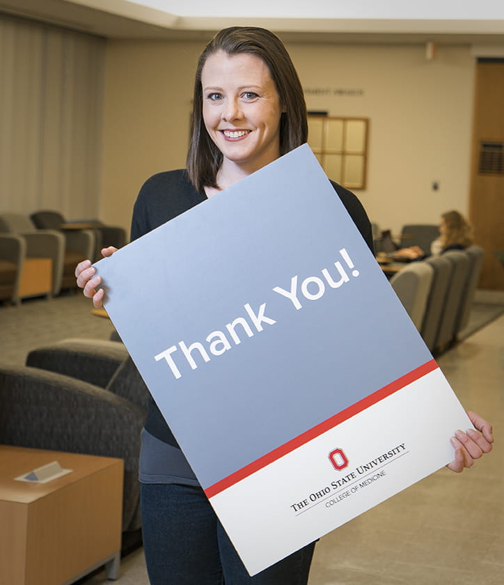 Karen Thatcher holding a thank you  poster 