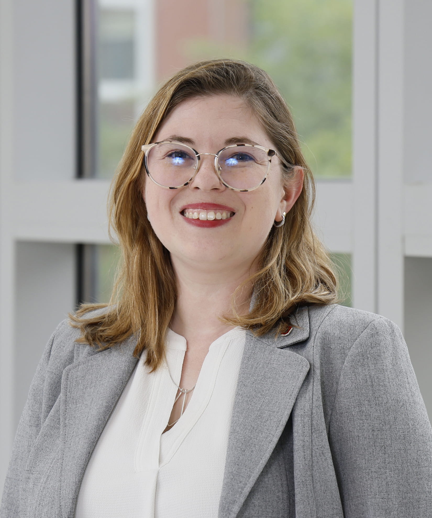 Sarah Anderson smiling in professional attire.