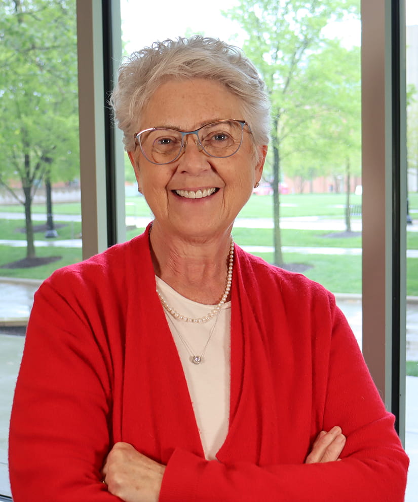 Headshot of Marcia Nahikian-Nelms wearing a red sweater