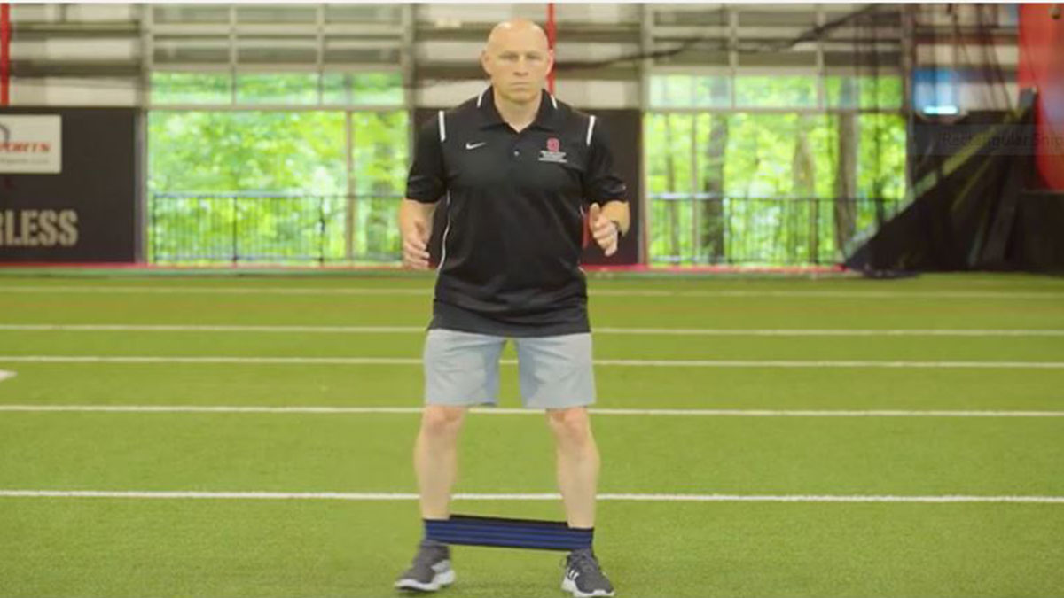Chris Kolba demonstrates resisted side-step exercise to strengthen hip muscles.