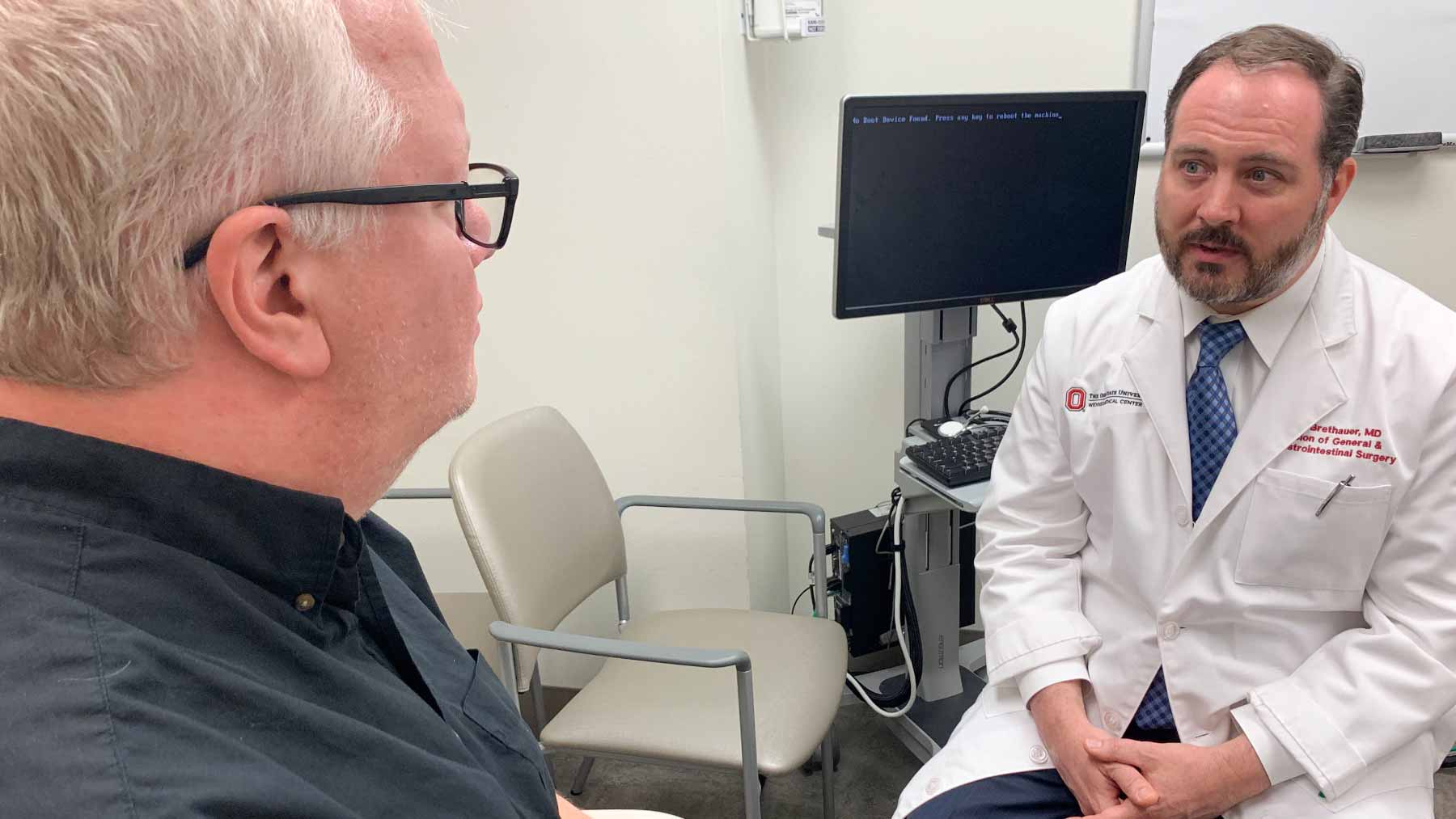 Dr. Stacy Brethauer discusses bariatric surgery with a patient.