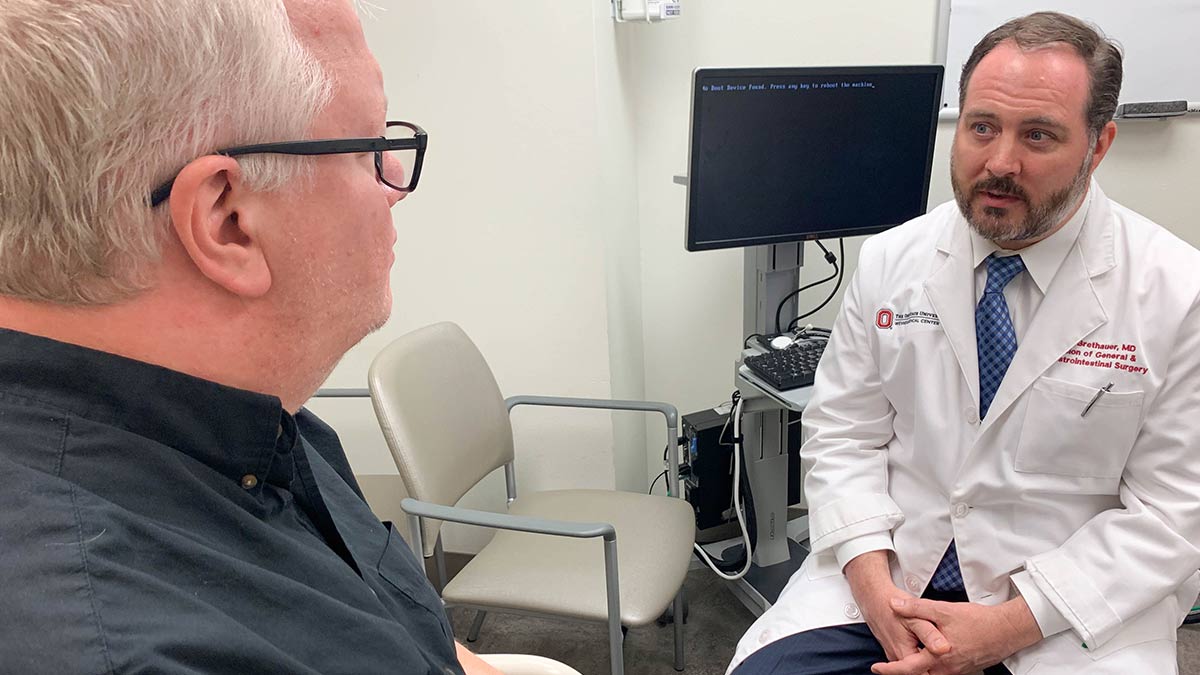 Dr. Stacy Brethauer discusses bariatric surgery with a patient.