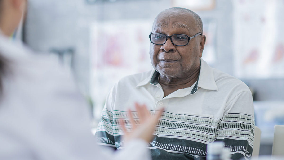 elderly overweight man listening to doctor