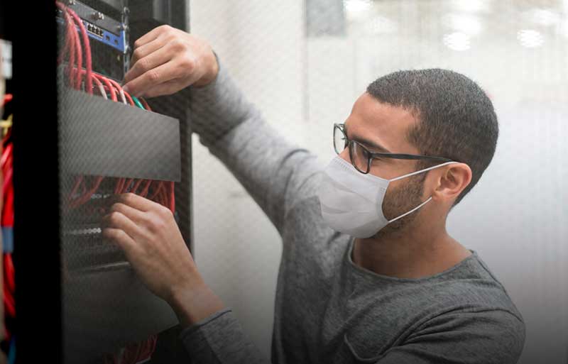 IT professional working on a server tower